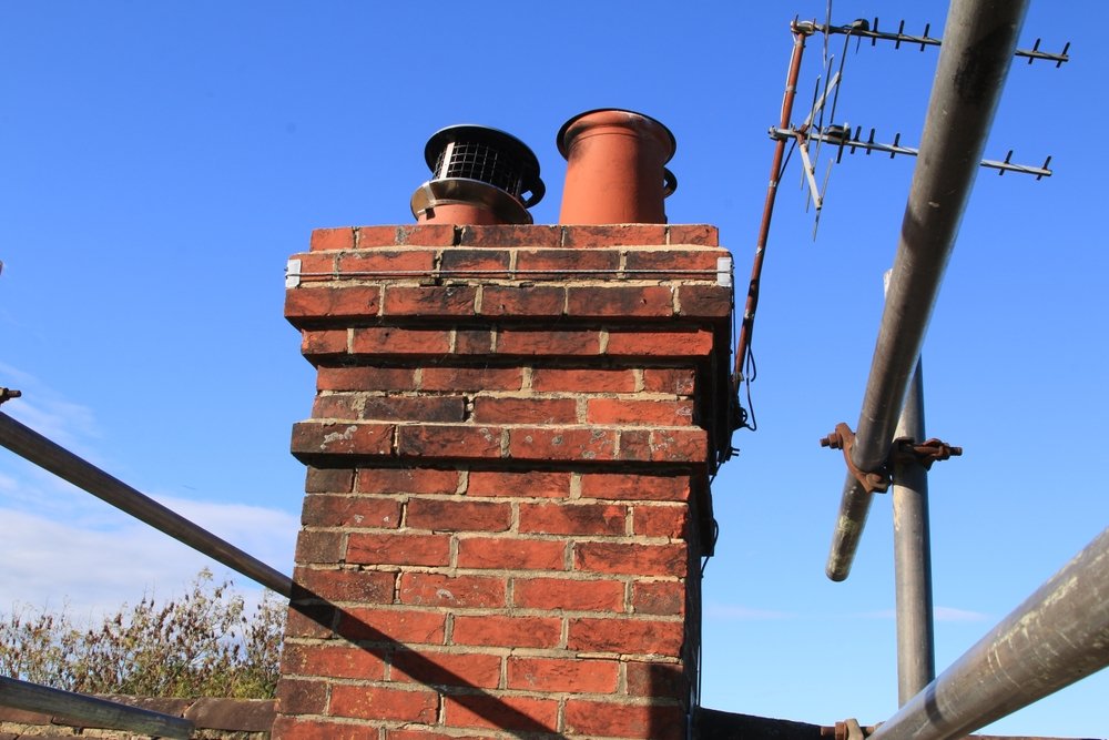 old,brick,chimney,stack,in,need,of,repointing